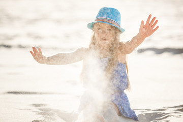 Little girl on the sand. Child in the desert