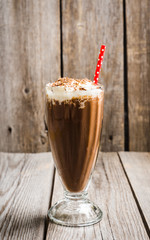 Chocolate milkshake on the rustic background. Selective focus.
