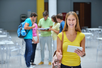 Portrait of a young student standing outside with friends in the background