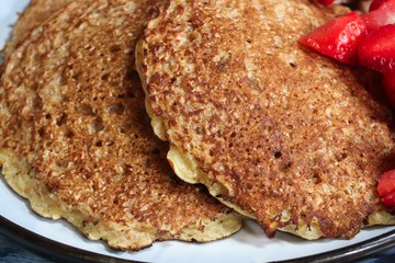 Homemade Oat  wheat Bran Pancakes served with fresh strawberries and banana