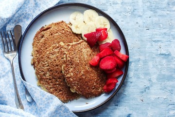 Homemade Oat  wheat Bran Pancakes served with fresh strawberries and banana