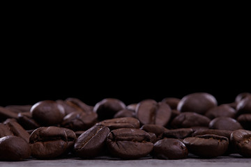 Coffee beans isolated on wooden surface black background
