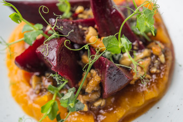 Vegan pumpkin puree with roast beetroot, close up