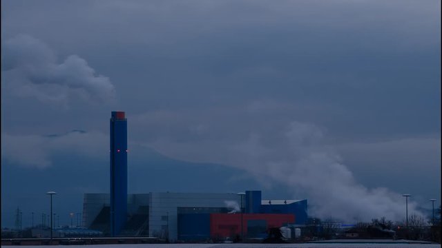 Turin, Gerbido, Piedmont Italy March 17 2018. The waste-to-energy plant of the company TRM-GRUPPO IREN. The cold and overcast weather enhance the fumes and the steam emitted from the system. Time laps
