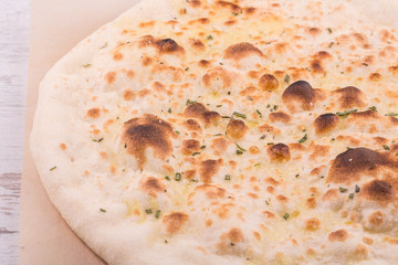 The focaccia baked in the furnace with grated cheese and greens