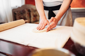 Obraz na płótnie Canvas Male chef hands and dough, strudel cooking
