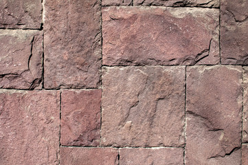 House wall decorative facing slabs of red sandstone closeup as background