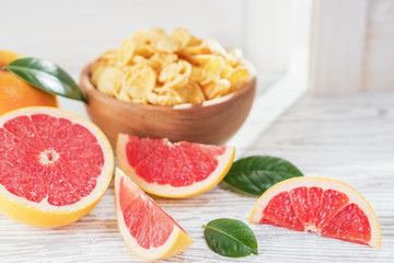 Ripe grapefruits on rustic white wooden background, close-up. Healthy dietary food breakfast.