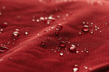 Rain Water droplets on  red waterproof fabric