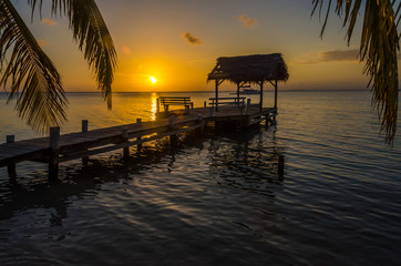 Sunset at South Water Caye - Small tropical island at Barrier Reef with paradise beach - known for diving, snorkeling and relaxing vacations - Caribbean Sea, Belize, Central America