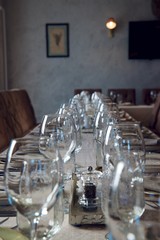Clear glasses and dishes on the table in the restaurant