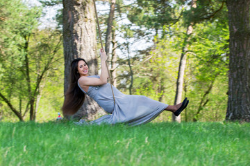 pregnant woman on a swing