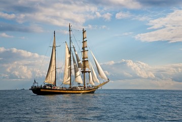 Naklejka na ściany i meble Tall ship race in the Black sea. Large white sails on masts. Beauty seascape.