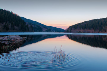 Mountain Lake at sunset with water splash
