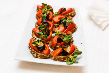Making dietary sandwiches with grilled tomatoes and eggplant mozzarella and rye bread