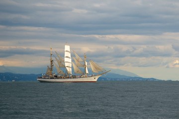 Fototapeta na wymiar Tall ship race in the Black sea. Large white sails on masts. Beauty seascape.