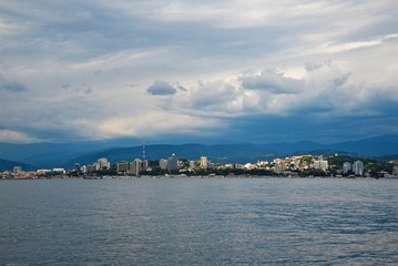 Fototapeta premium Seaside of the Sochi city. High buildings on the coast. Beauty sky clouds. 