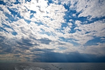Beauty sky clouds over sea. Sunny afternoon.