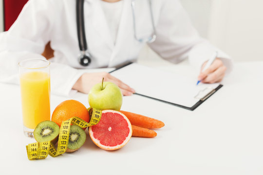 Nutritionist desk with fruit and measuring tape