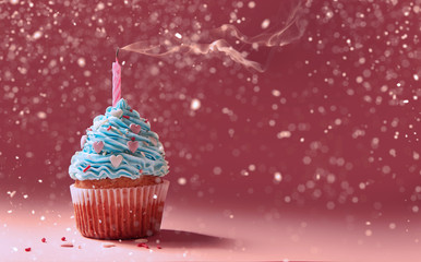 muffin with cream and extinguished candle. the concept of the end of the celebration.