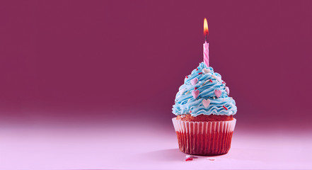 muffin or a small cake with a burning candle. concept of congratulation, holiday.