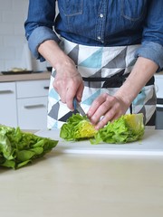 woman slices salad