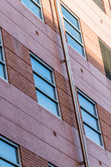 Modern building facade detail. Detail of a brick house with windows.