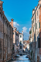 Canal and historic buildings of Venice, Italy. Narrow canal, old houses, reflection on water on a sunny day in  Venice, Italy.