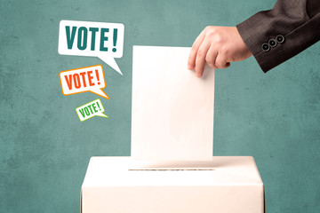 placing a voting slip into a ballot box