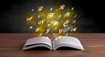 Alphabet letters over book