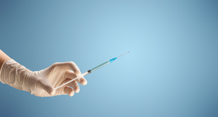 Female doctor holding syringe