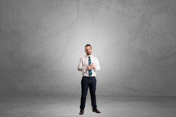 Alone businessman standing in a dark room