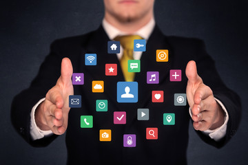 Businessman holding colorful applications
