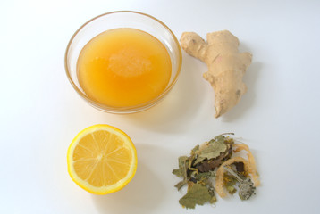 tea lemon honey and ginger on white background