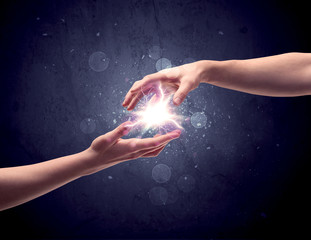 Hands reaching to light a spark