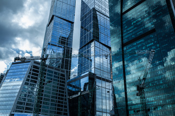 Detail blue glass building background with cloud sky