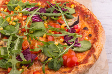 Pizza for vegetarians with vegetables and greens