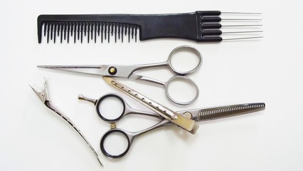 Hairdressing tools on white background.