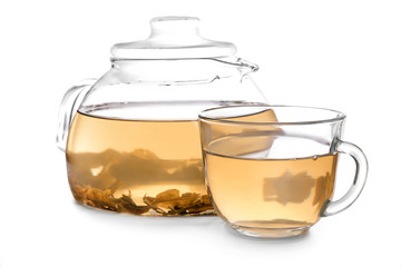 Glass teapot and cup with delicious hot beverage on white background