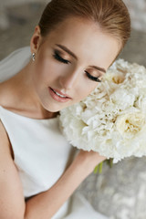 Portrait of beautiful and sensual blonde model girl with closed eyes and professional makeup - bride's morning