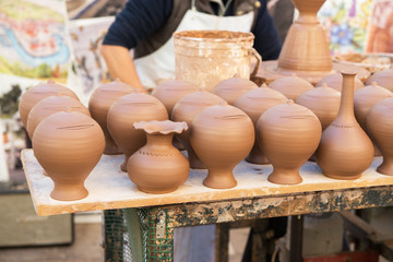Fototapeta na wymiar Pottery. Craft, handicraft. Clay pots are sold on the street.