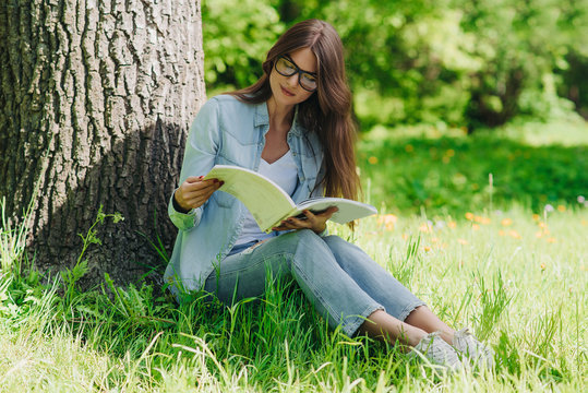 Woman reading a book in park