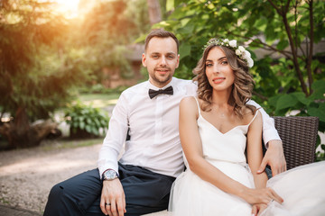 Fototapeta premium the bride and groom sit on a chair