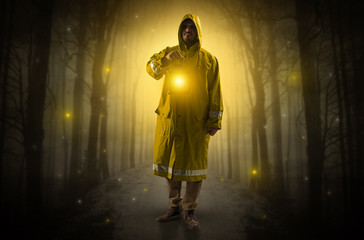 Fototapeta na wymiar Mysterious man coming from a path in the forest with glowing lantern concept