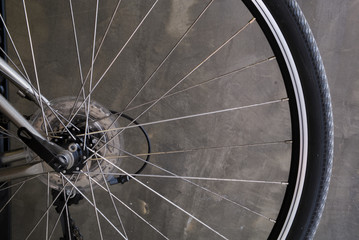 Bicycle wheel on cement wall background