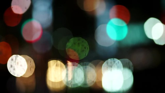 雨の日の繁華街を行き交う人々と車（ボケ表現・夜景・ネオン）