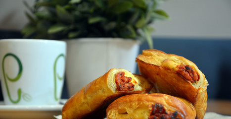 Pizza small scrolls food with coffee. Delicious salted breakfast.