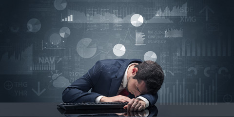 Businessman sleeping with charts, graphs and reports concept