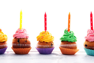 Tasty cupcakes on wooden background. Birthday cupcake in rainbow colors