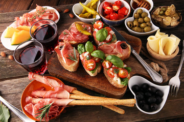 Italian antipasti wine snacks set. Cheese variety, Mediterranean olives, pickles, Prosciutto di...